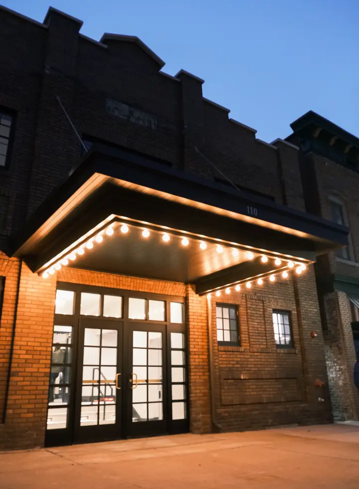 Front entrance of the Dawn Theater with glowing marquee lights