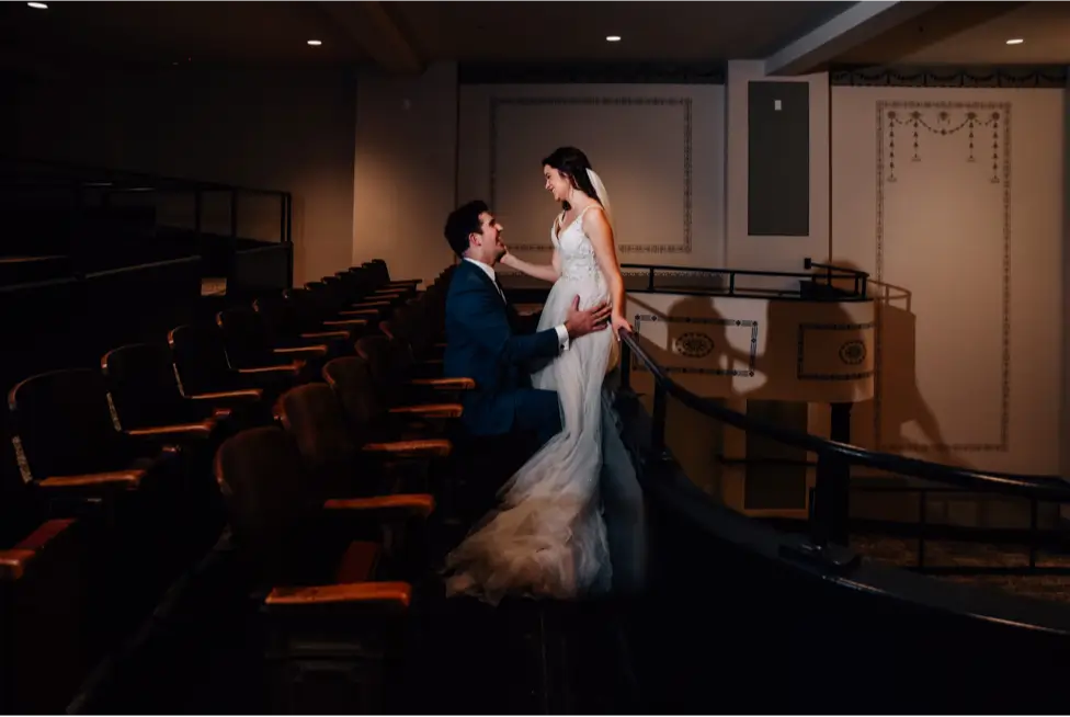 bride and groom gazing at each other in the dawn theater balcony