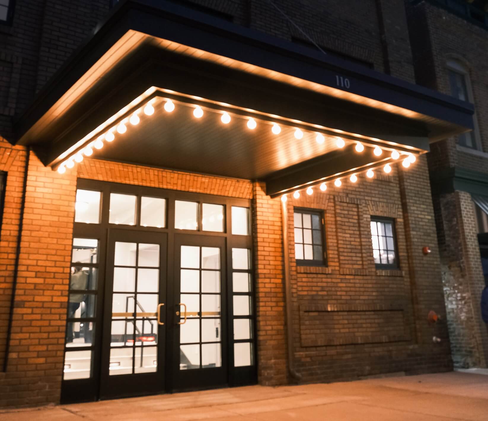 Dawn Theater front entrance illuminated by the glow of the marquee lights