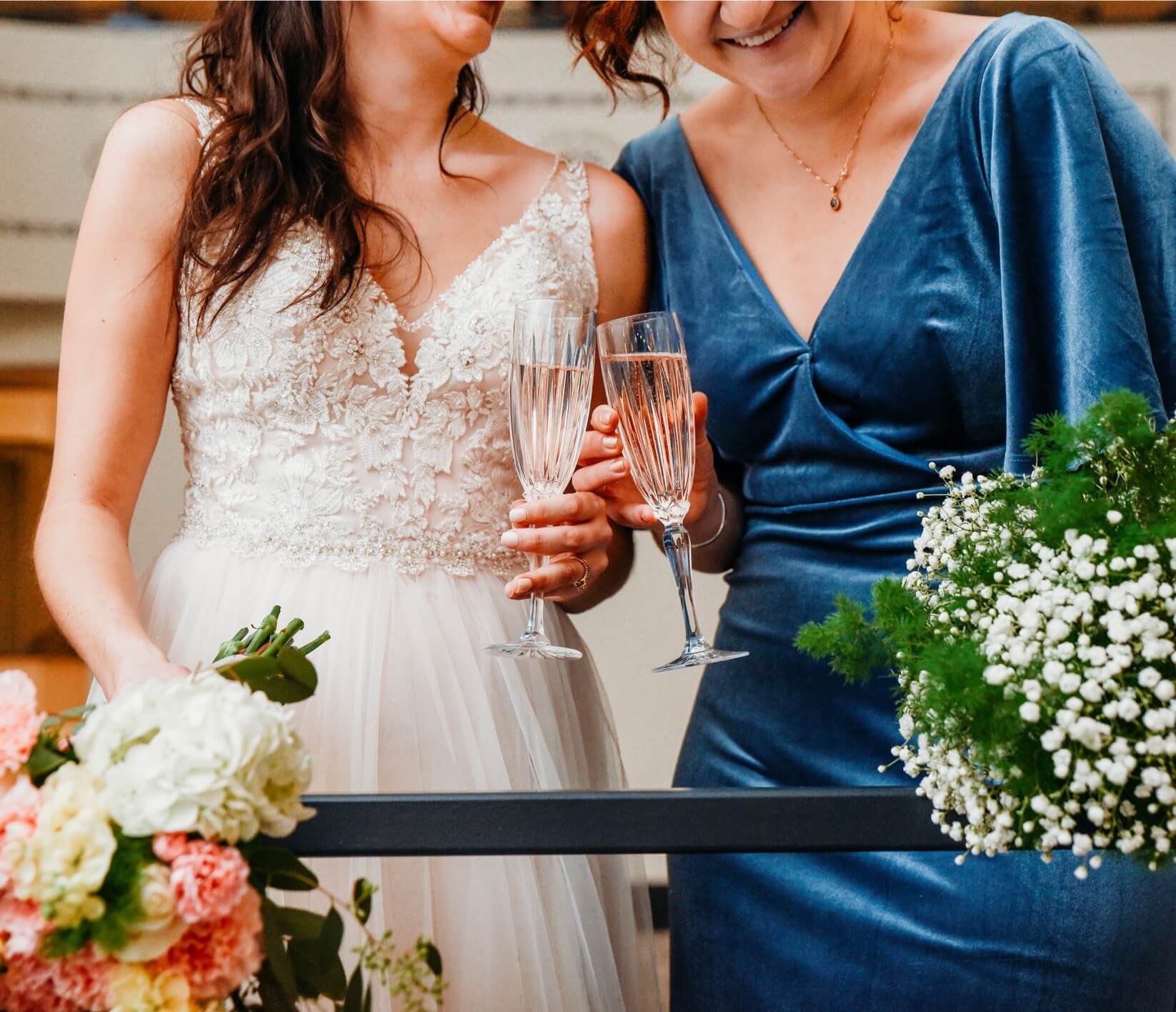 Bride and Bridesmaid toasting a glass of champagne at the Dawn Theater
